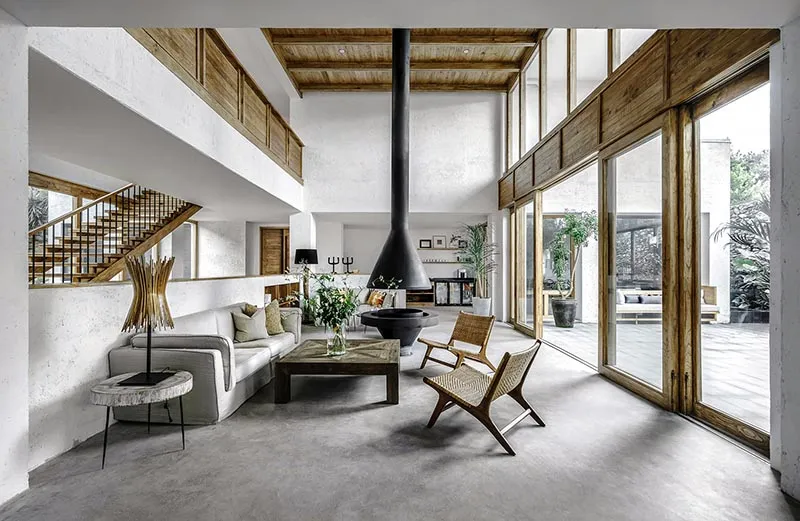Modern interior design featuring a concrete floor and wooden furniture in a living room setting.