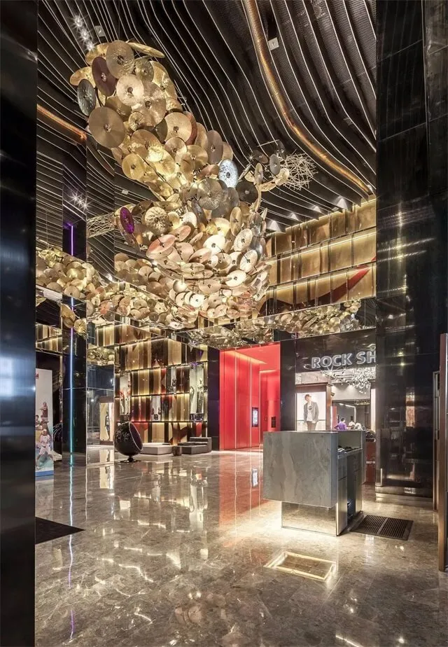 A modern lobby featuring metallic ceiling sculptures.