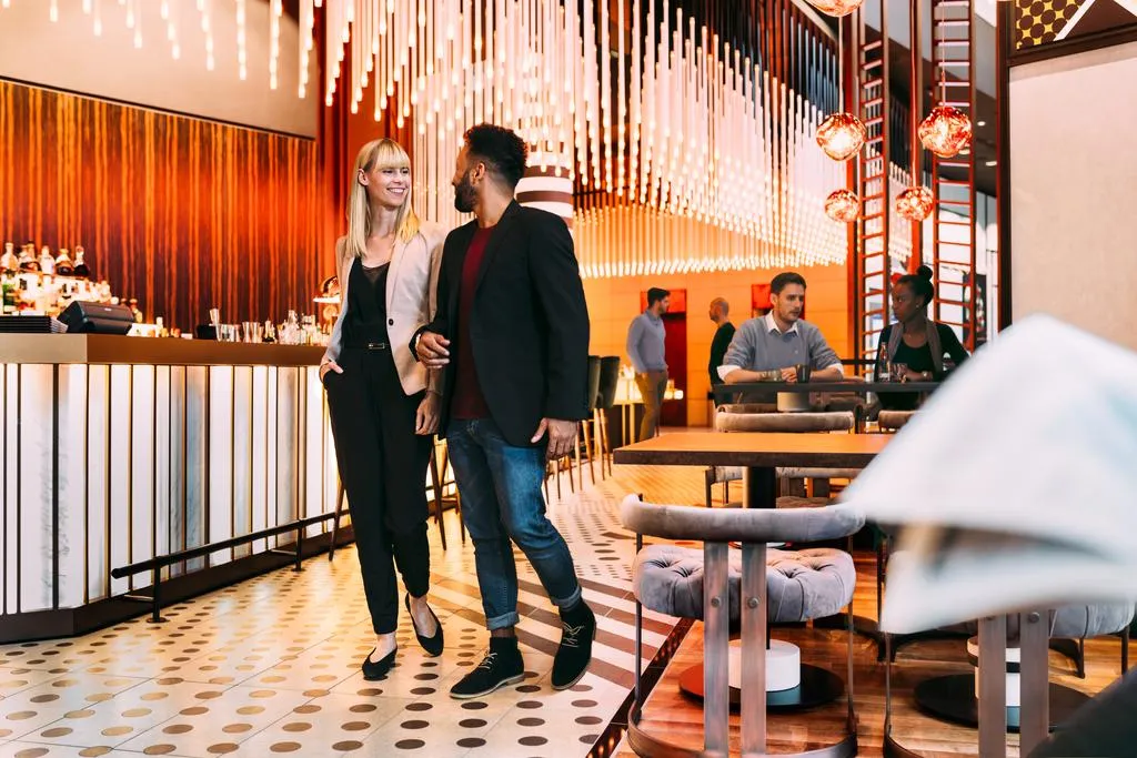 A modern restaurant bar interior with contemporary design elements and lighting fixtures.