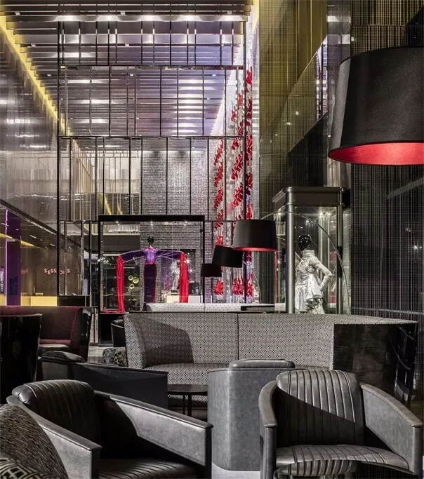 A modern retail storefront featuring metallic furniture and illuminated signage.