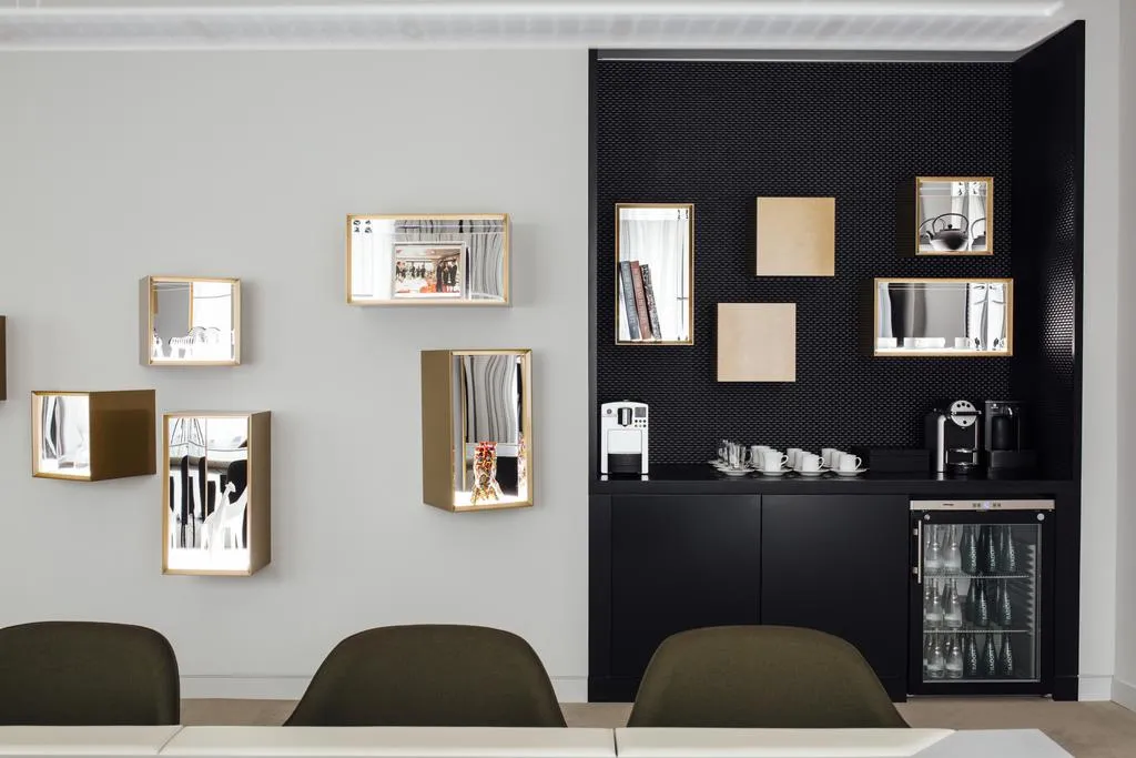 Modern coffee counter featuring black and white design elements with a matching black floor and white ceiling.