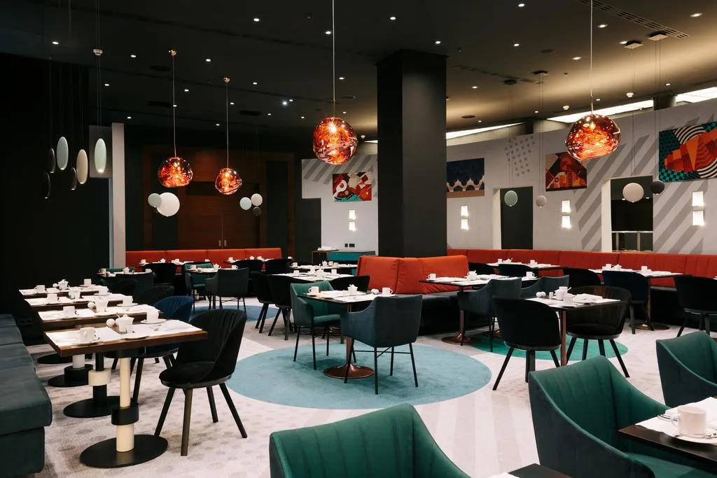 Modern restaurant interior with textured furniture and glass sphere light fixtures