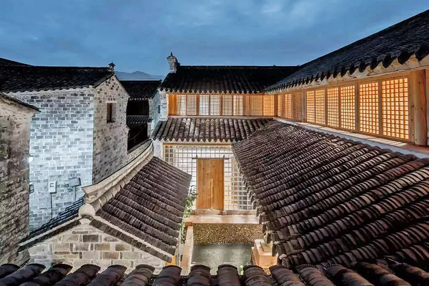 A traditional Chinese architecture interior with clay-tiled rooftops and wooden lattice windows.