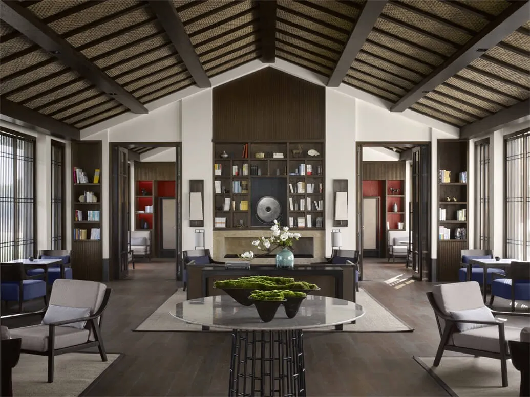Contemporary living room with wooden and concrete finishes, featuring comfortable seating and a central coffee table.