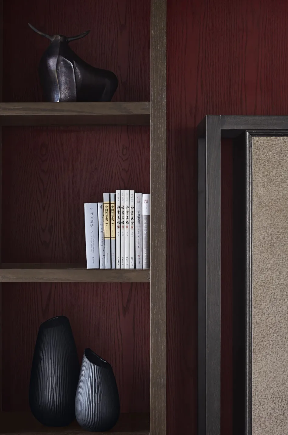 A modern interior with minimalist design features a wooden shelving unit.