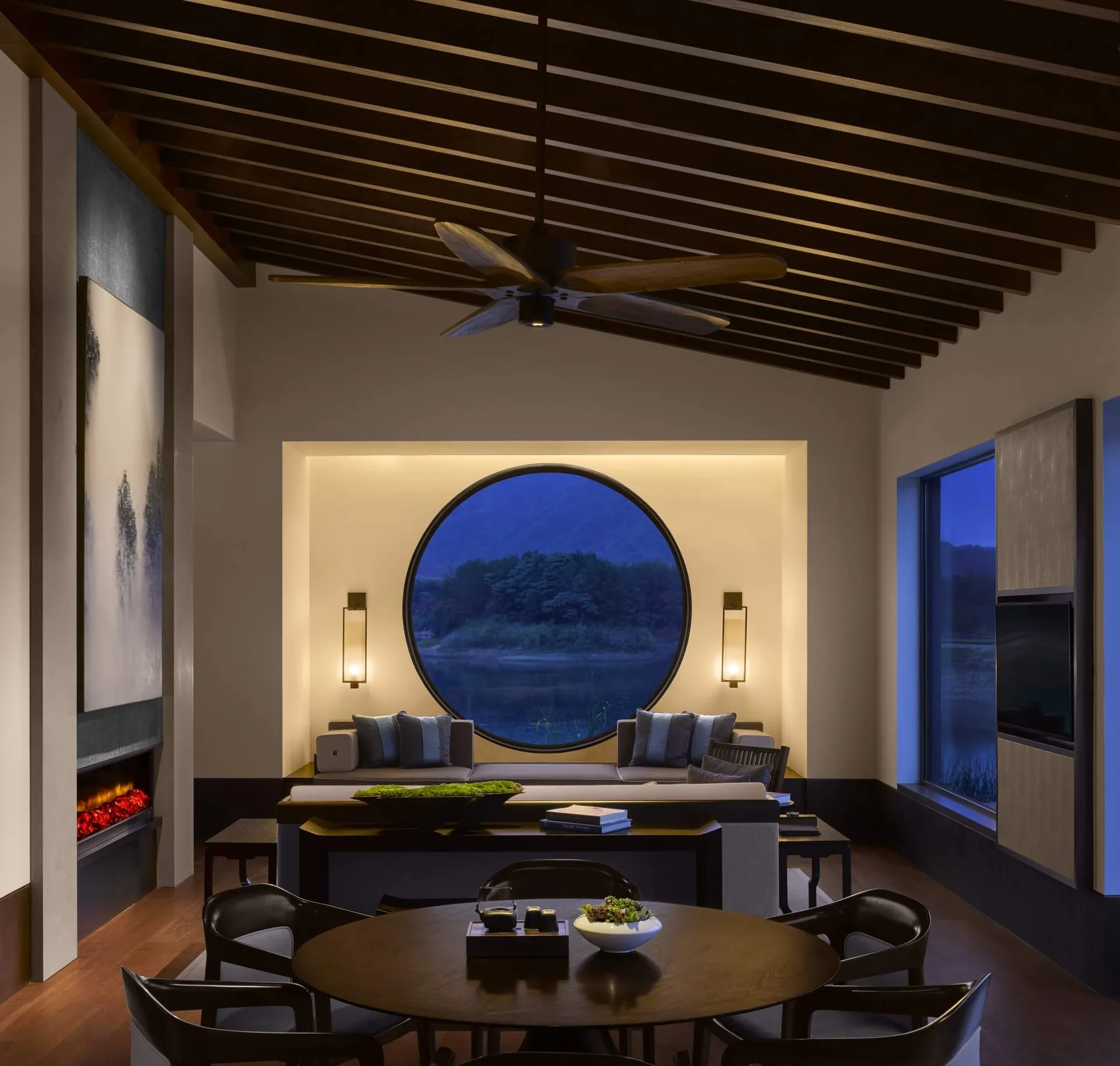 A modern living room featuring mixed materials and a dark interior design.