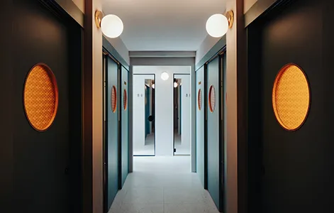 A modern corridor featuring metallic and textured materials.