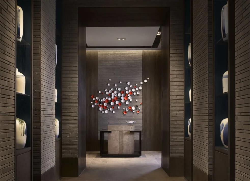 A modern lobby featuring stone walls and ceramic tiles