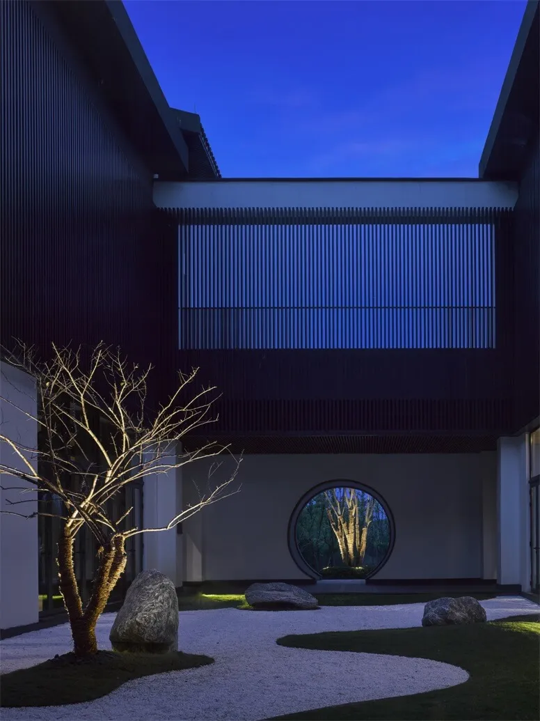 A modern residential space featuring black wood and circular window.