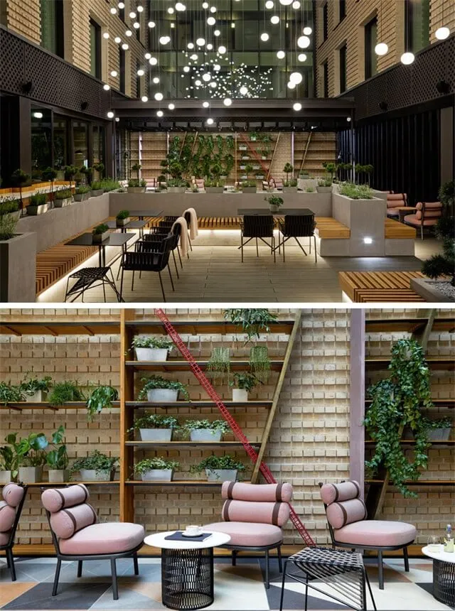 Modern indoor lounge area with concrete walls, seating, and potted plants.