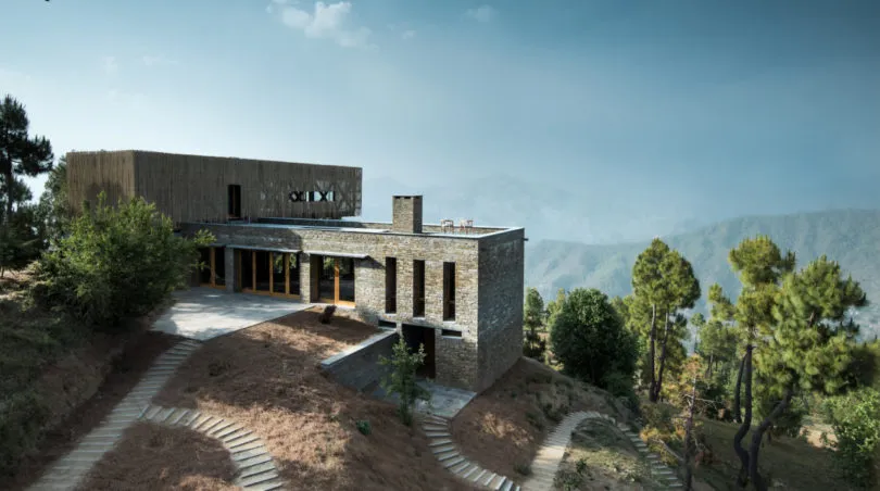 Modern residential architecture featuring stone and glass materials.