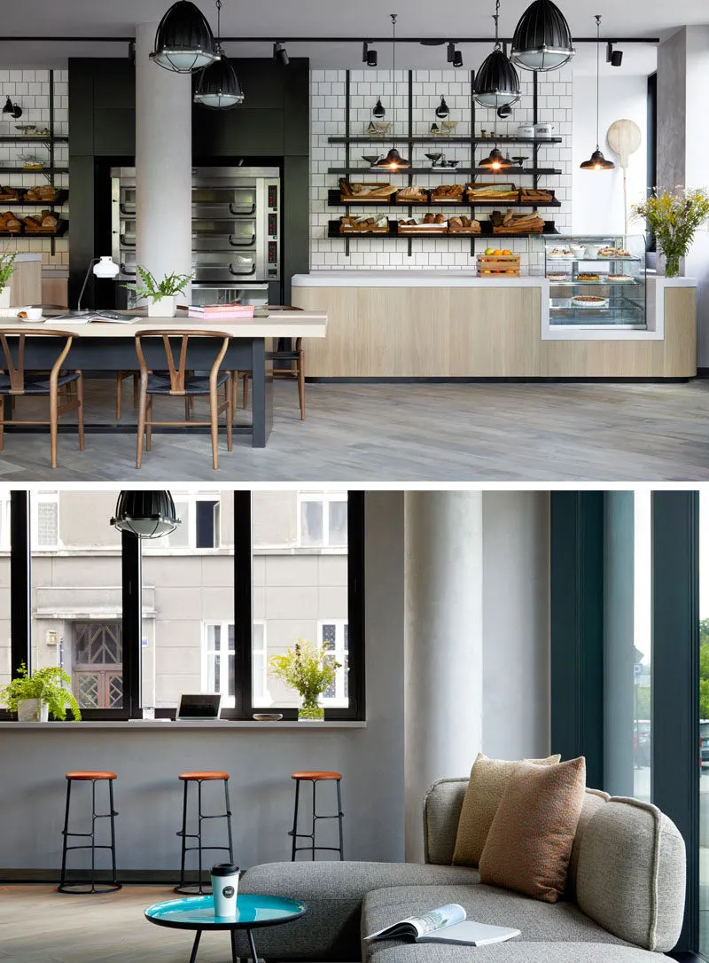 A modern restaurant with wooden tables, concrete flooring, and industrial lighting.