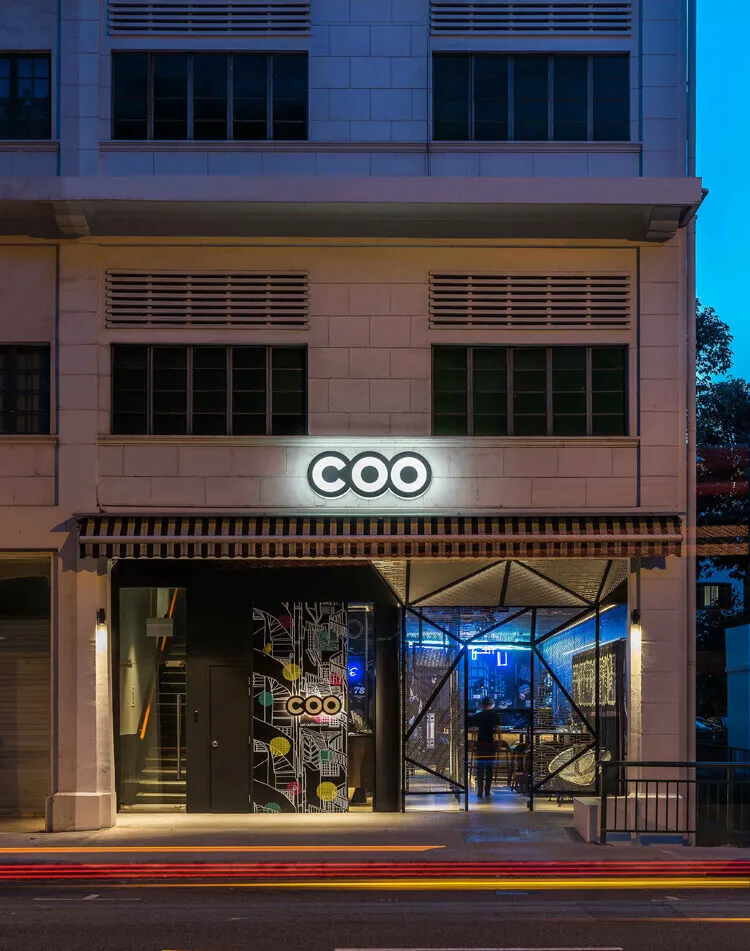Modern storefront entrance with concrete texture and colorful patterns