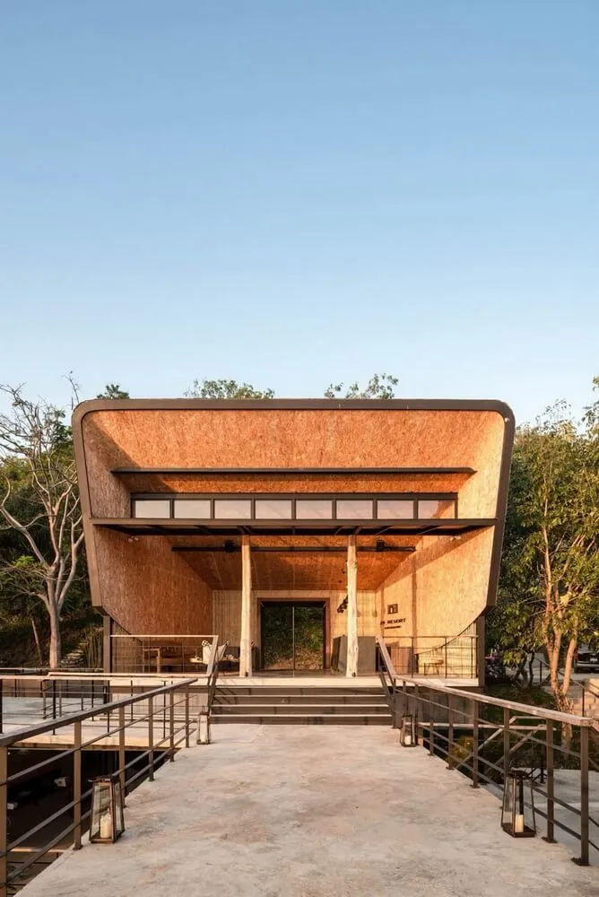 Modern building with copper-colored cladding and large windows.