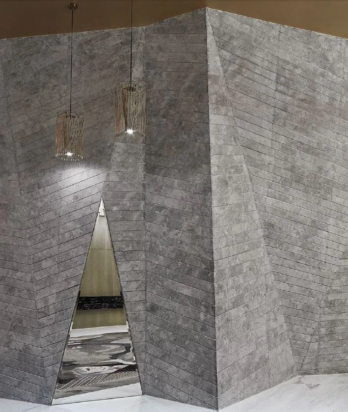 A modern industrial living space with concrete walls and a reflective mirror.