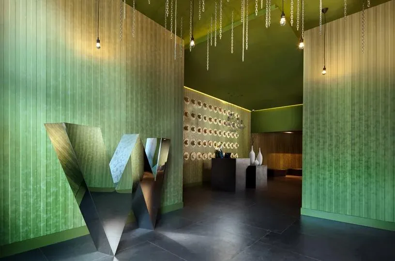 A modern restaurant lobby with metallic green features