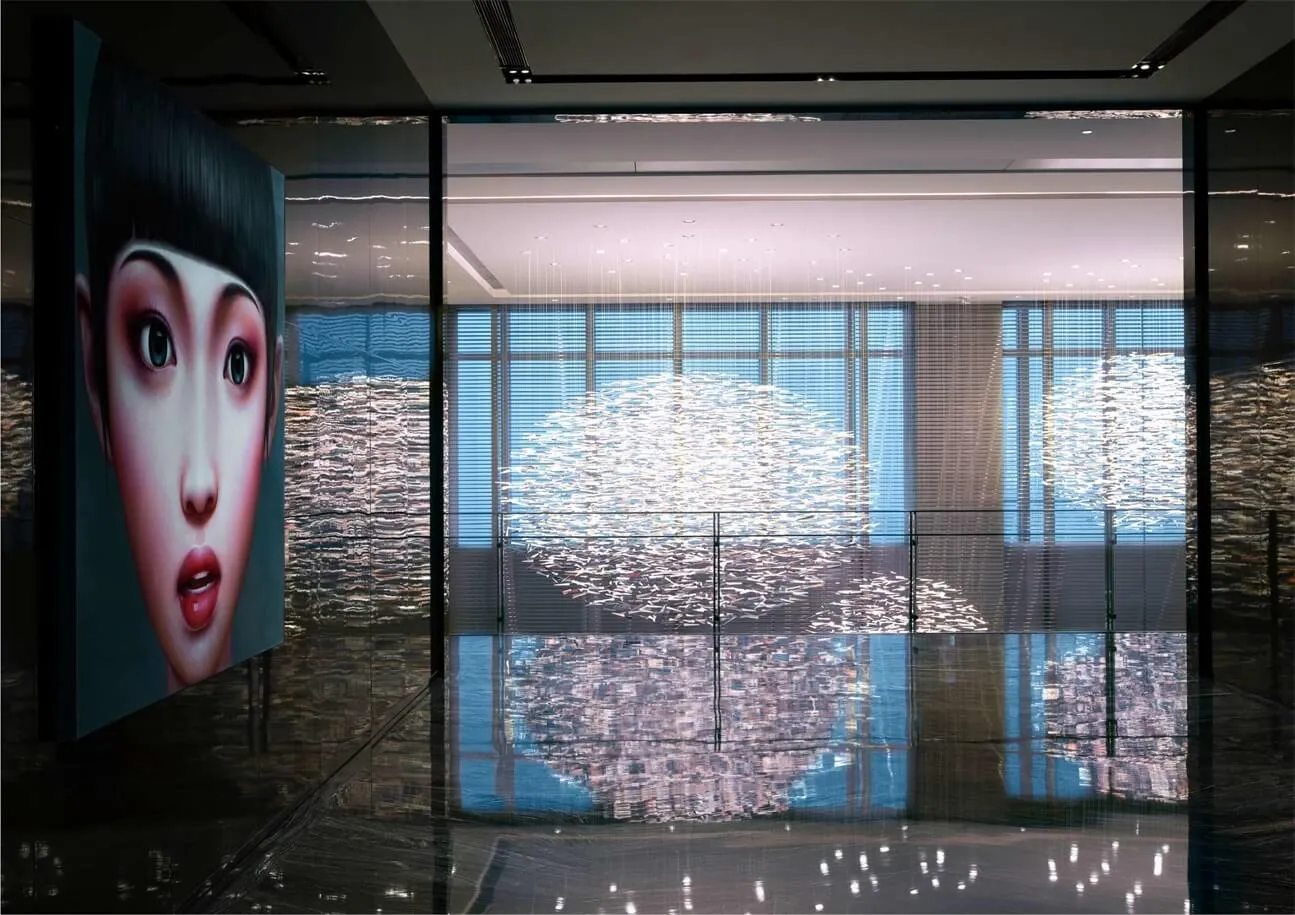 A glass storefront featuring a woman's face and a cityscape reflection.