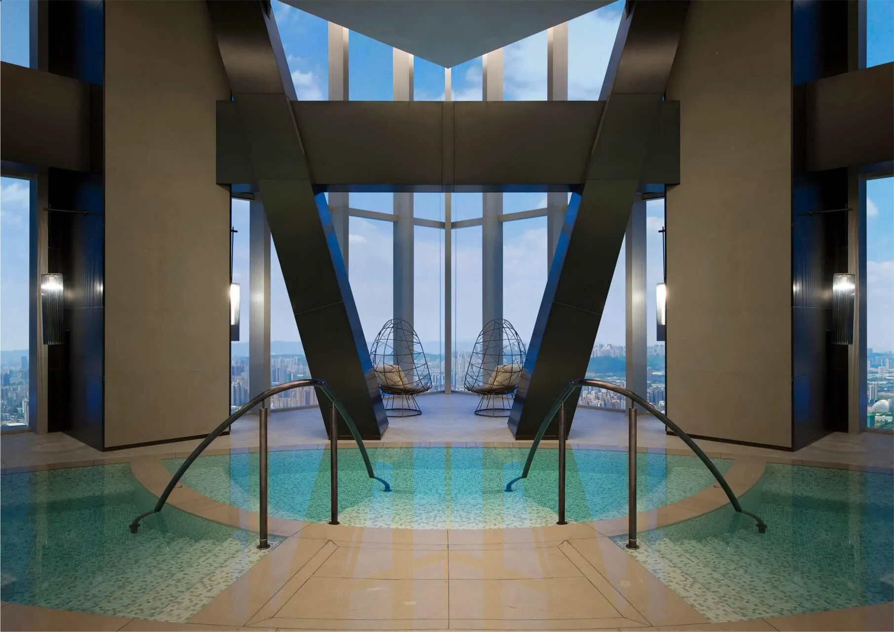 An indoor pool area with glass and marble features, designed for relaxation and luxury in a hotel suite.