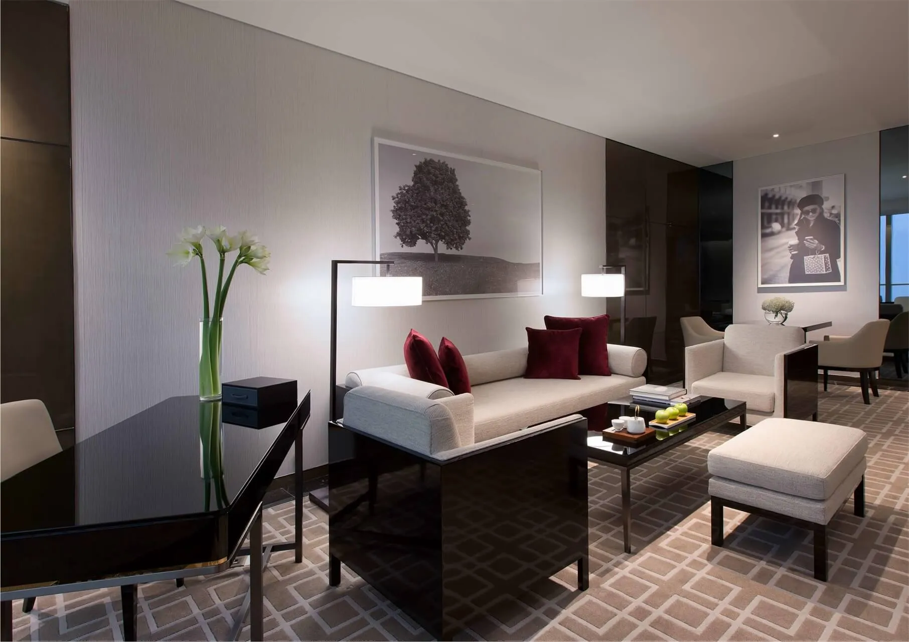 Modern living room featuring a comfortable sofa adorned with soft pillows and a stylish abstract painting behind it, with a s