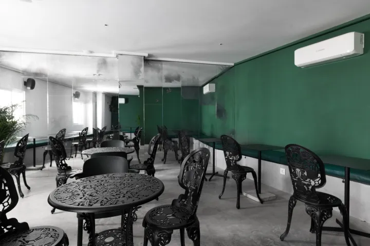 Industrial-style cafe interior featuring metal tables and chairs.