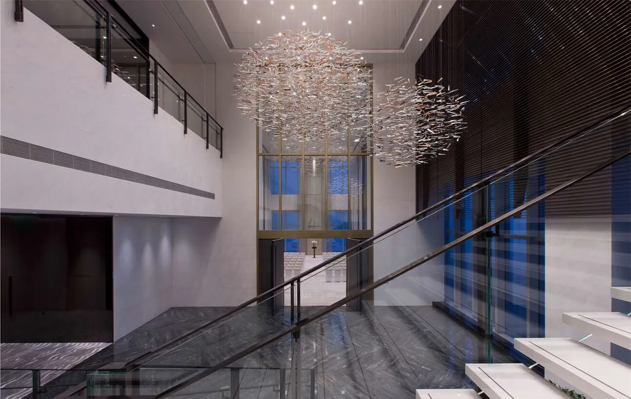A modern lobby featuring a glass chandelier.