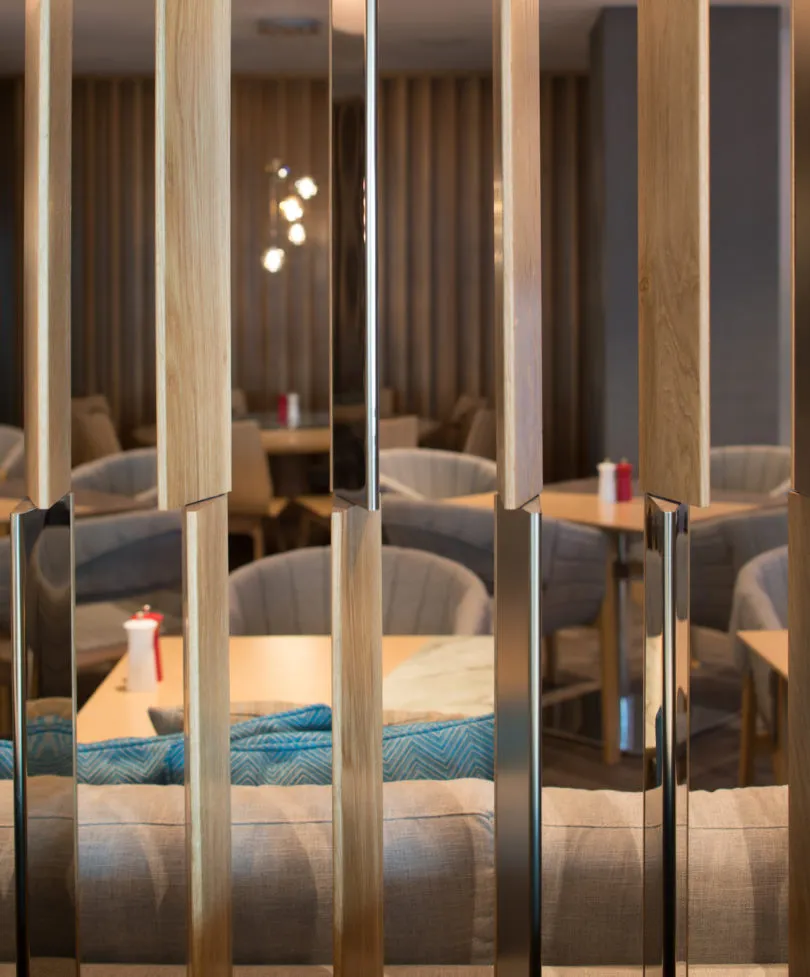 Wood and metal restaurant setting with modern furniture and tables.