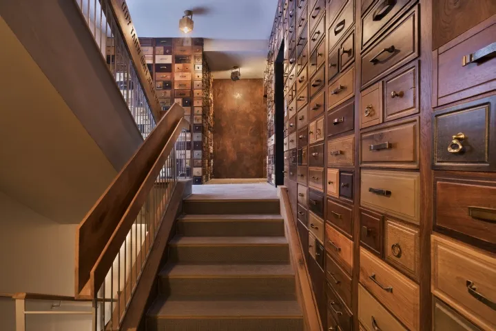 A modern industrial staircase with wooden steps and railings