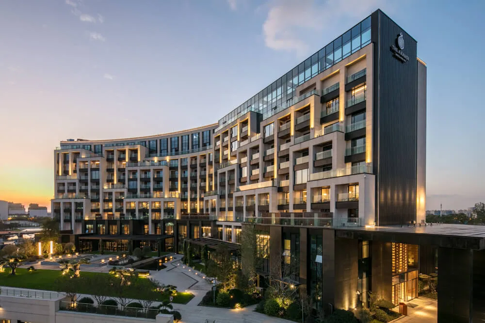 Modern hotel exterior with concrete, glass, and aluminum materials