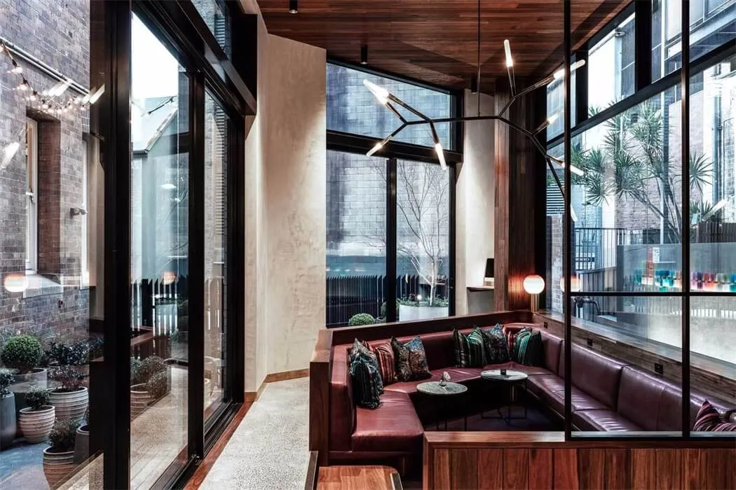 Modern, industrial restaurant interior with brick walls, concrete floors and wooden accents.
