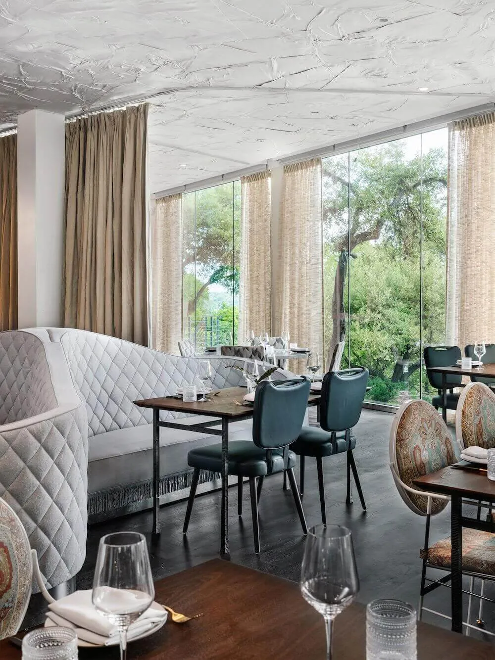 Modern restaurant interior with large windows and glass curtains