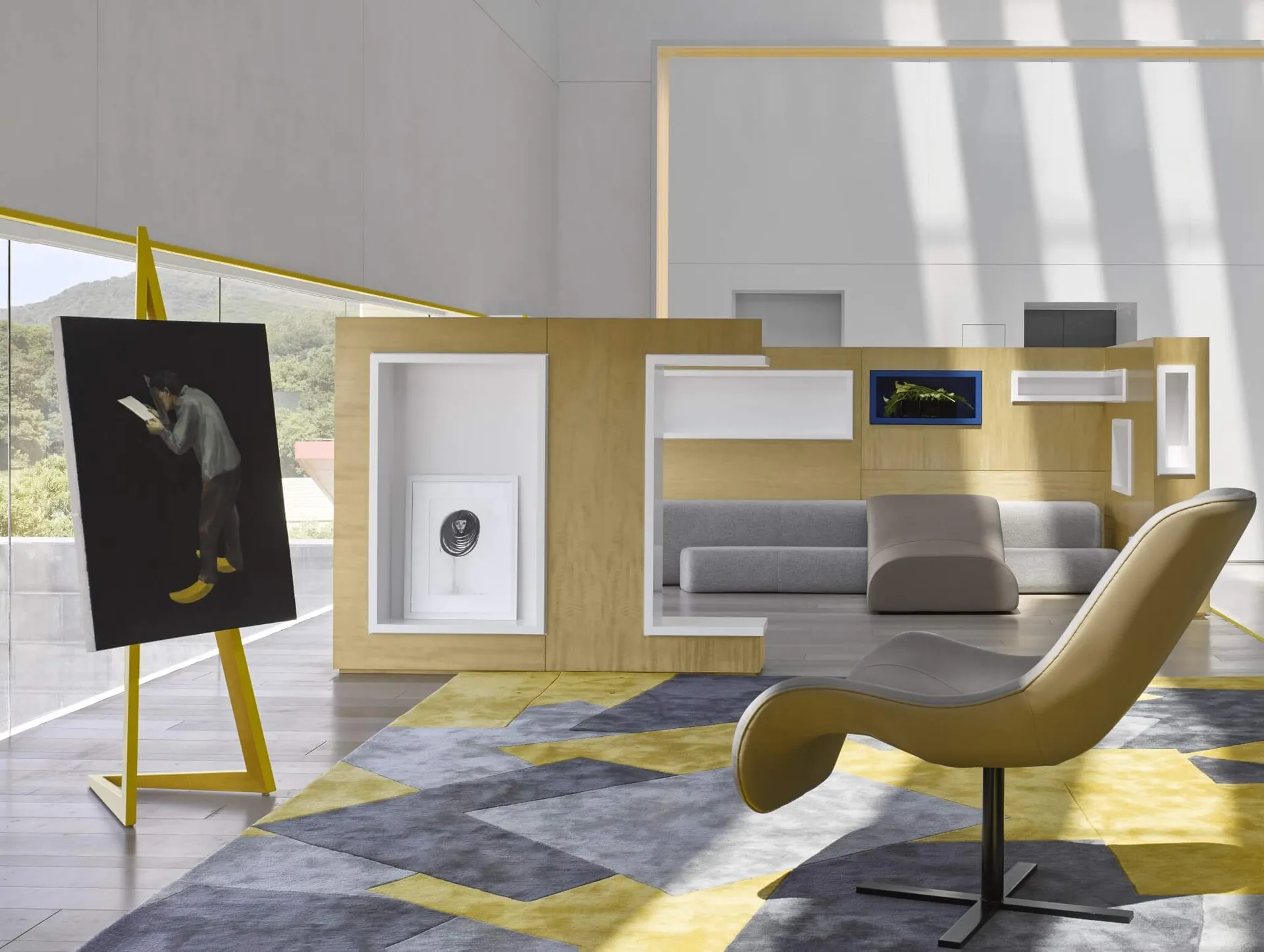 A minimalist living room with wood-paneled walls, a grey sofa, and a yellow leather armchair.