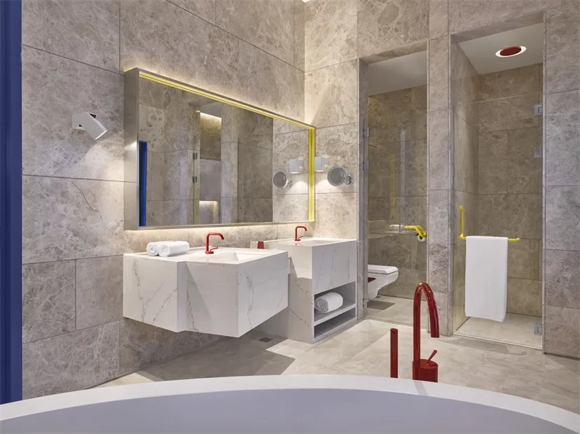 Modern bathroom interior with marble tiles and glass surfaces
