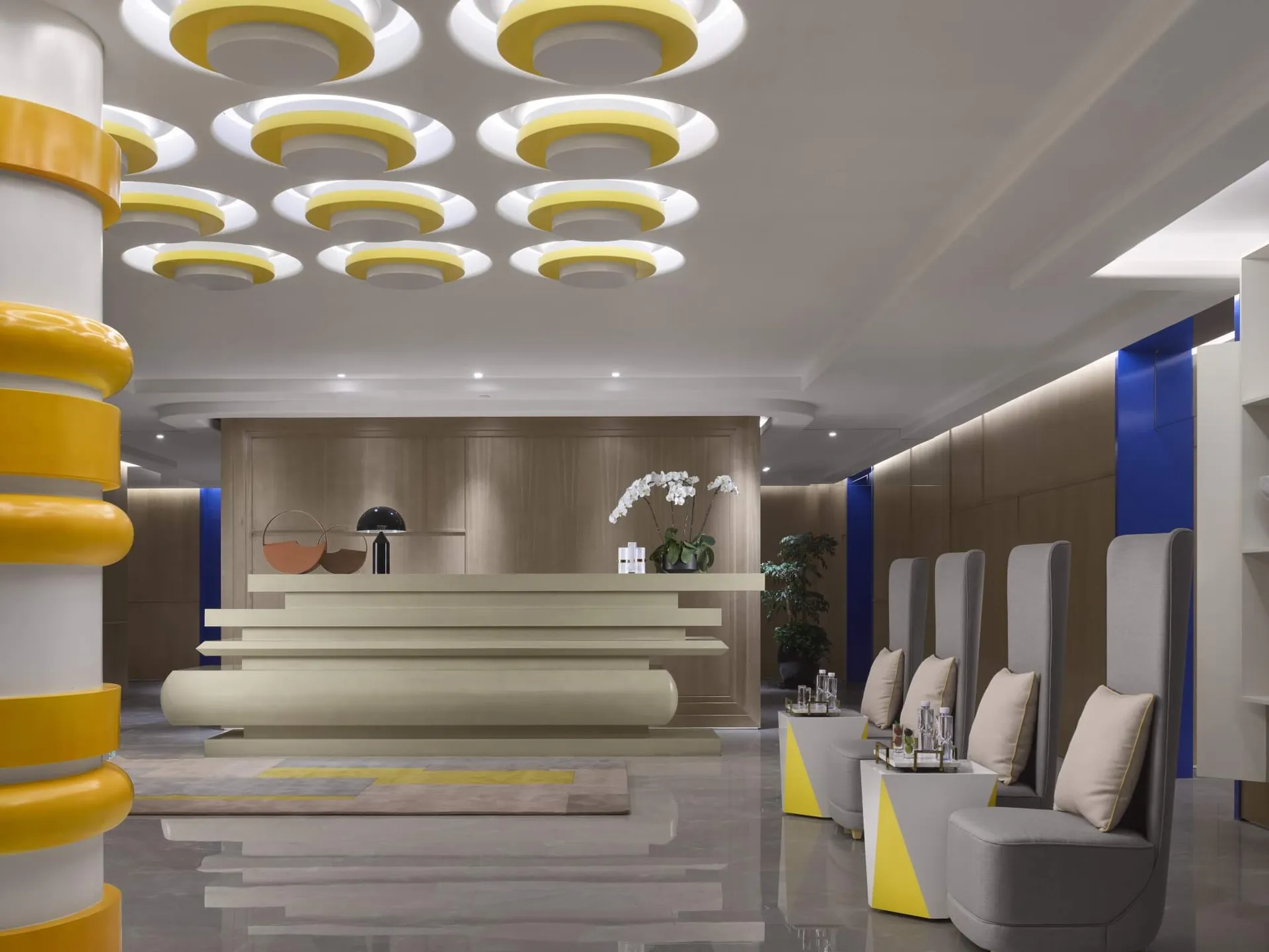 Contemporary lobby featuring modern construction materials, including concrete and yellow accents.