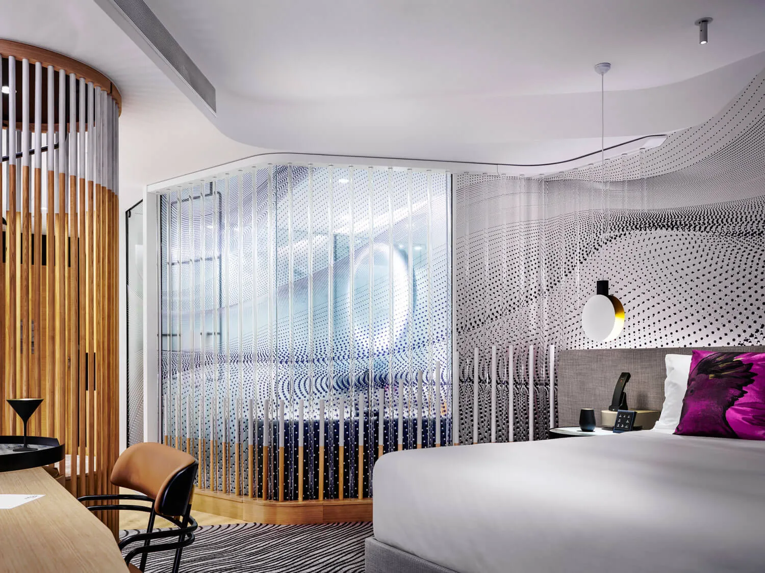 Modern minimalist bedroom featuring glass partitions, wooden accents, and fabric textures