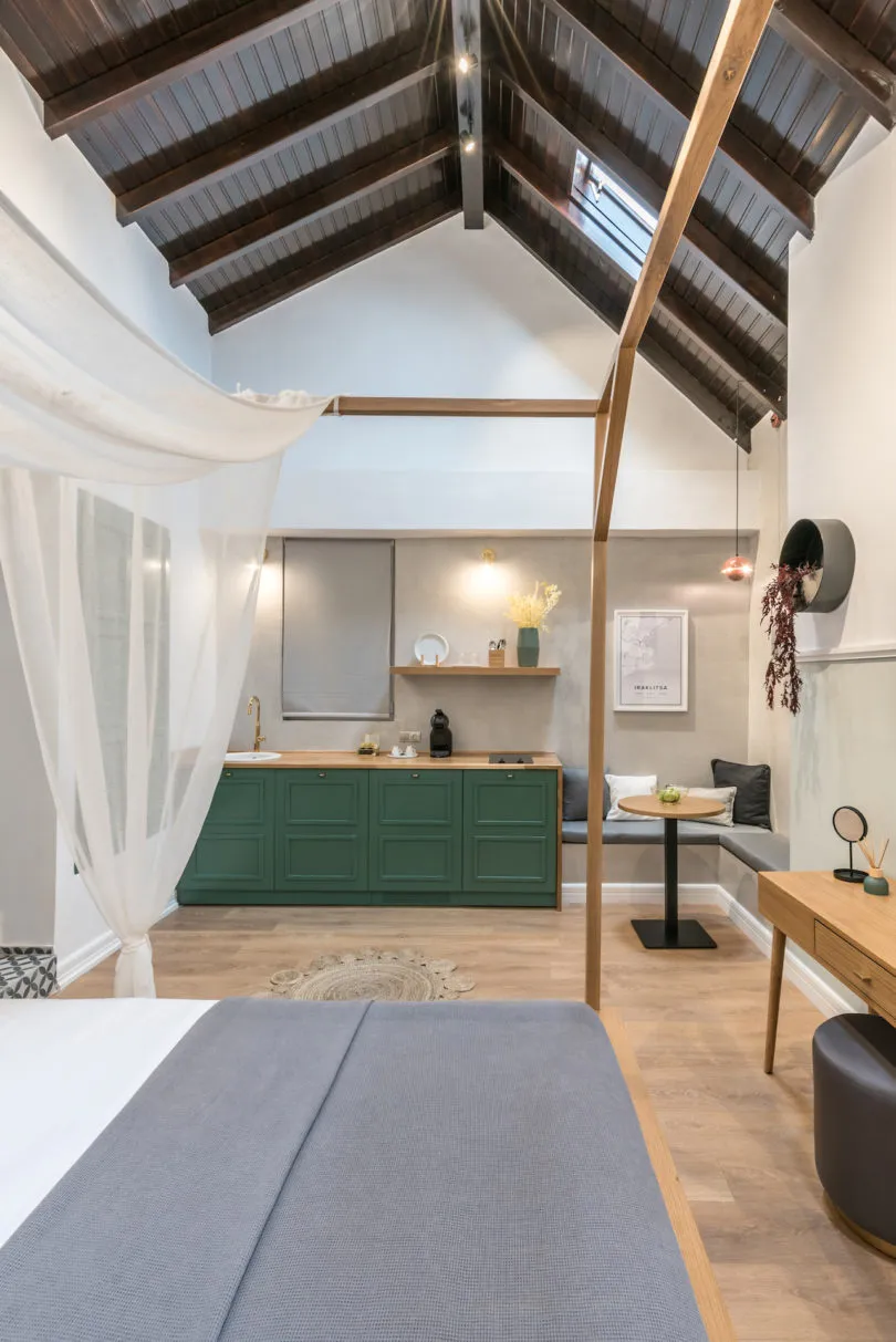 A minimalist residential interior featuring wooden furniture, concrete walls, and fabric curtains.
