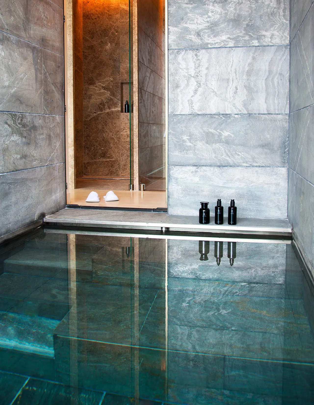 Modern spa pool area with glass water and minimalist design