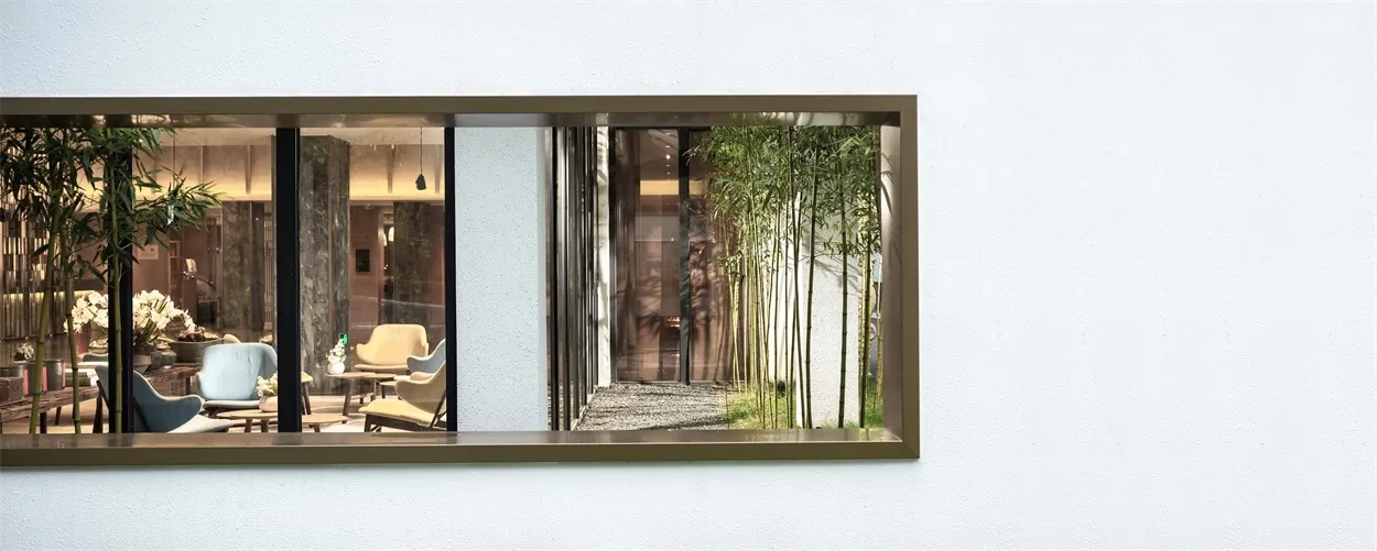A minimalist living space featuring glass and wooden accents.