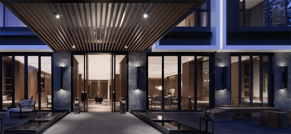 Modern hotel entrance featuring glass, wood, and stone materials
