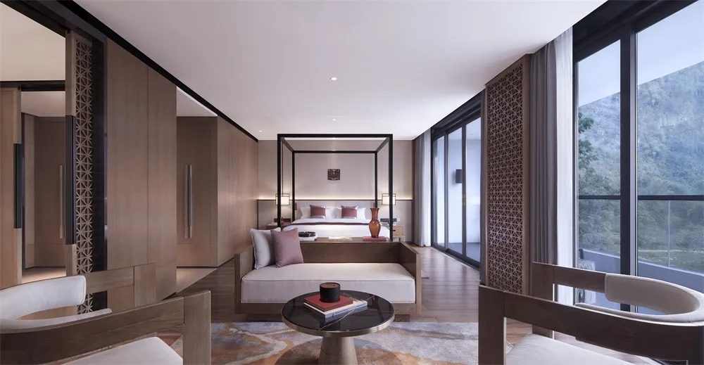 Modern hotel bedroom with wooden furniture and a view of the mountains.