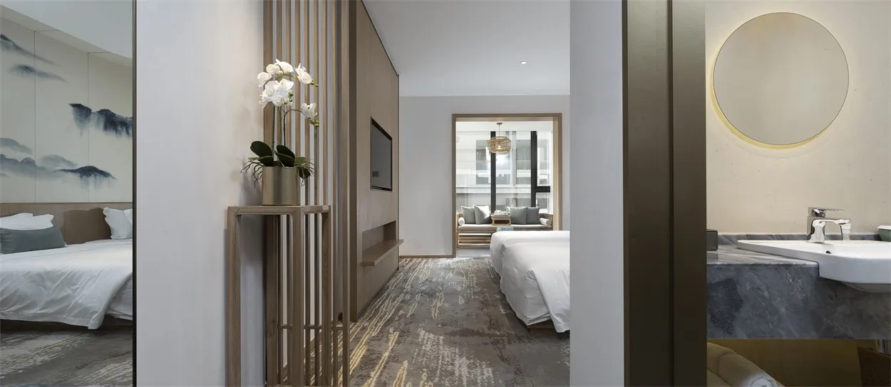 A modern hotel suite featuring white wood, marble, and fabric.