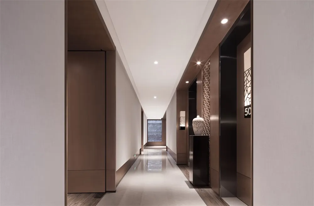 Modern interior design featuring sleek, minimalist design with wooden and glass elements in a corridor or hallway setting.