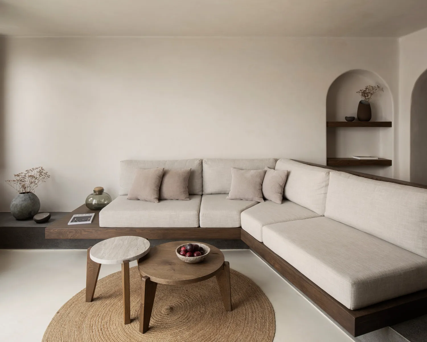 Minimalist living room with organic wood furniture and a circular jute rug.