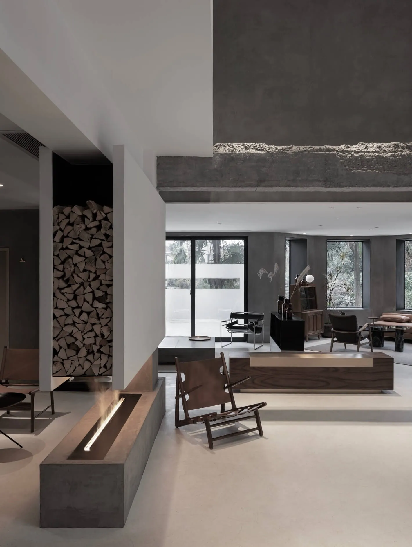 Modern living room with a concrete wall and minimalist furniture.