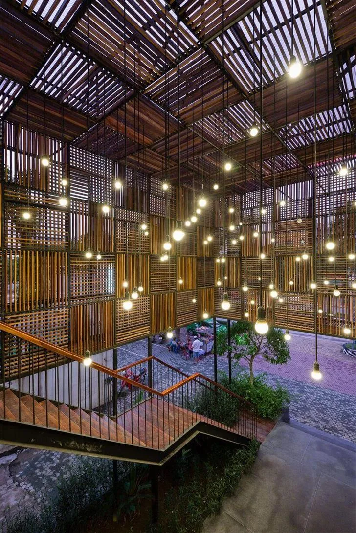 A modern lobby with a brick ceiling featuring exposed wooden beams and pendant lights.