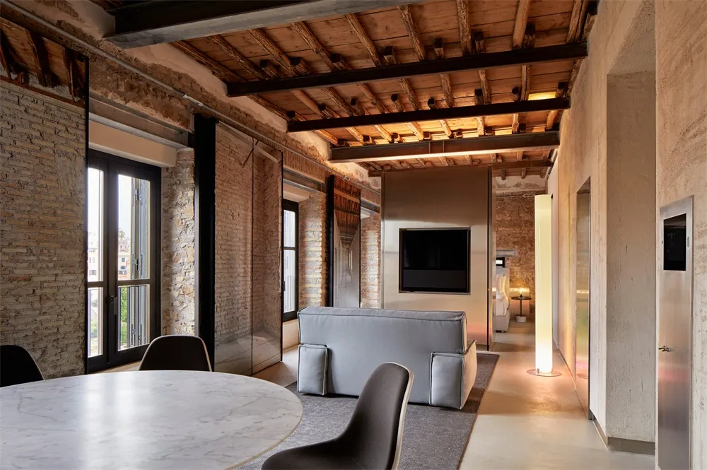 A modern interior space with exposed concrete walls and floors, and a minimalist design.