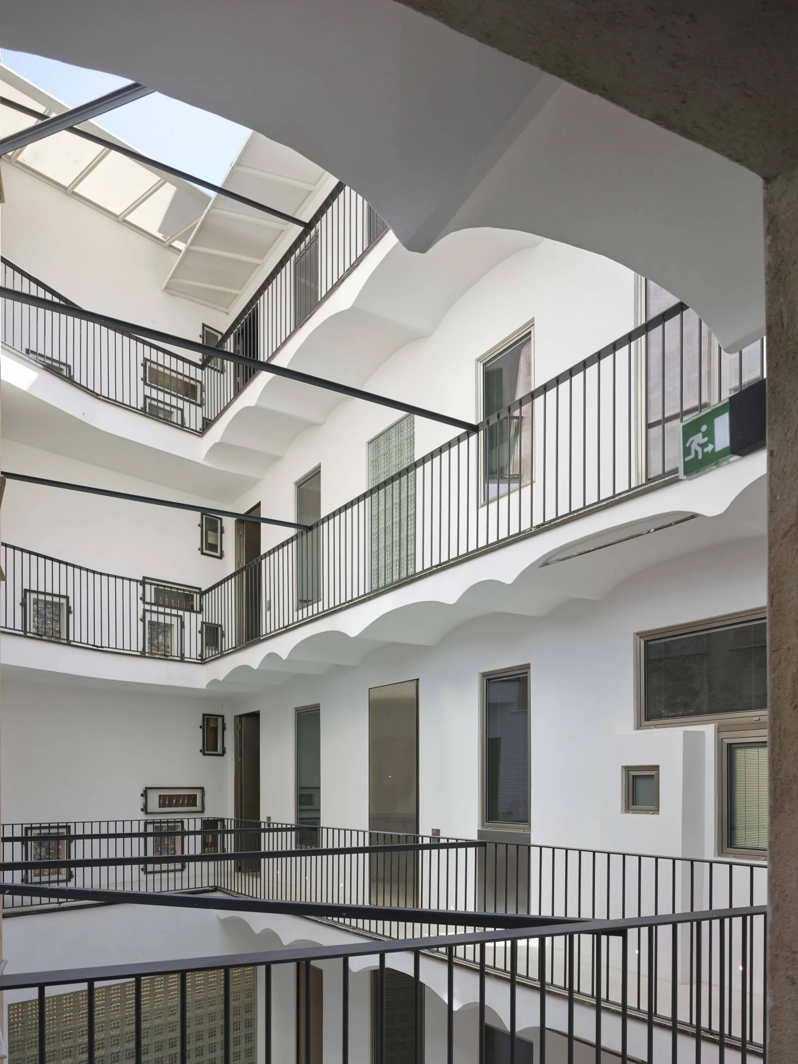 Modern interior design with glass and metal balconies.