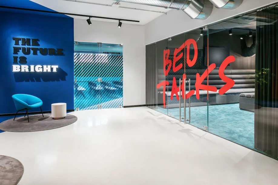 A modern office space featuring glass walls and minimalist design elements.