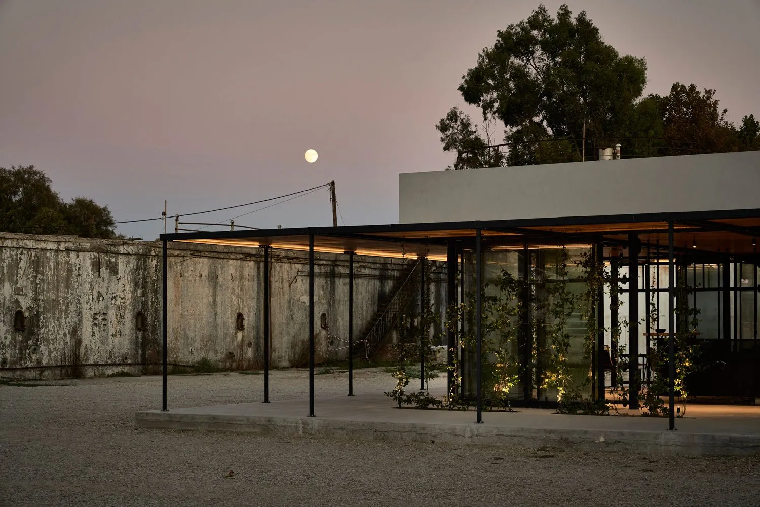 A minimalist residential structure with a concrete facade and a modern architectural design.