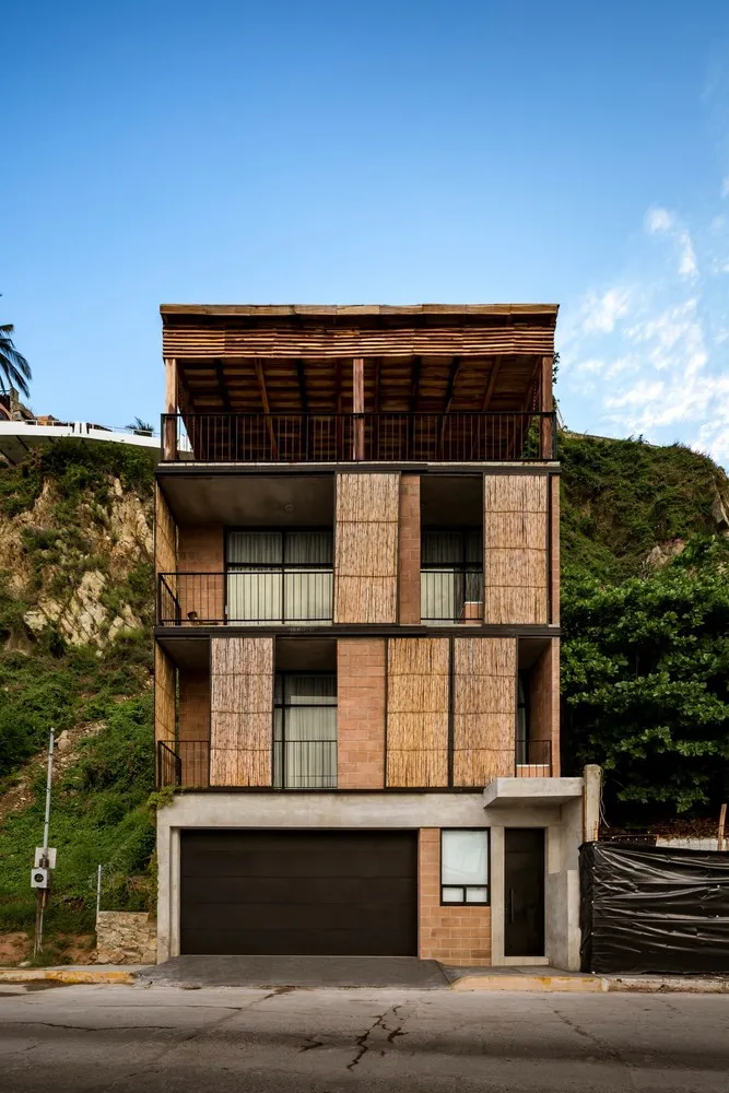 Modern residential building with wood cladding and concrete elements.