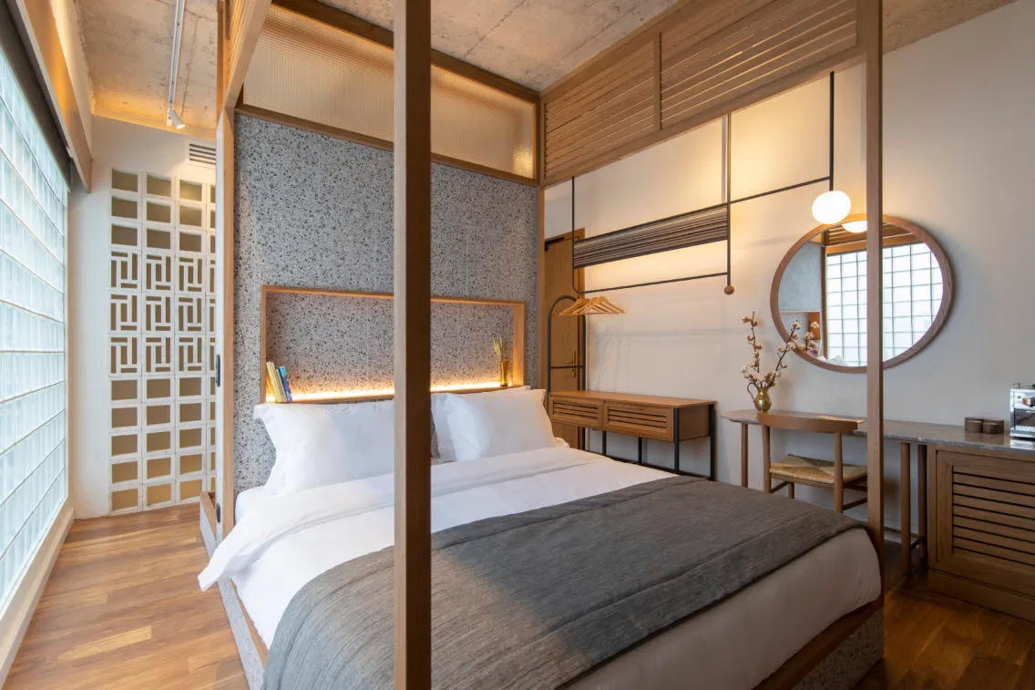 Modern bedroom with wooden features and a bed.